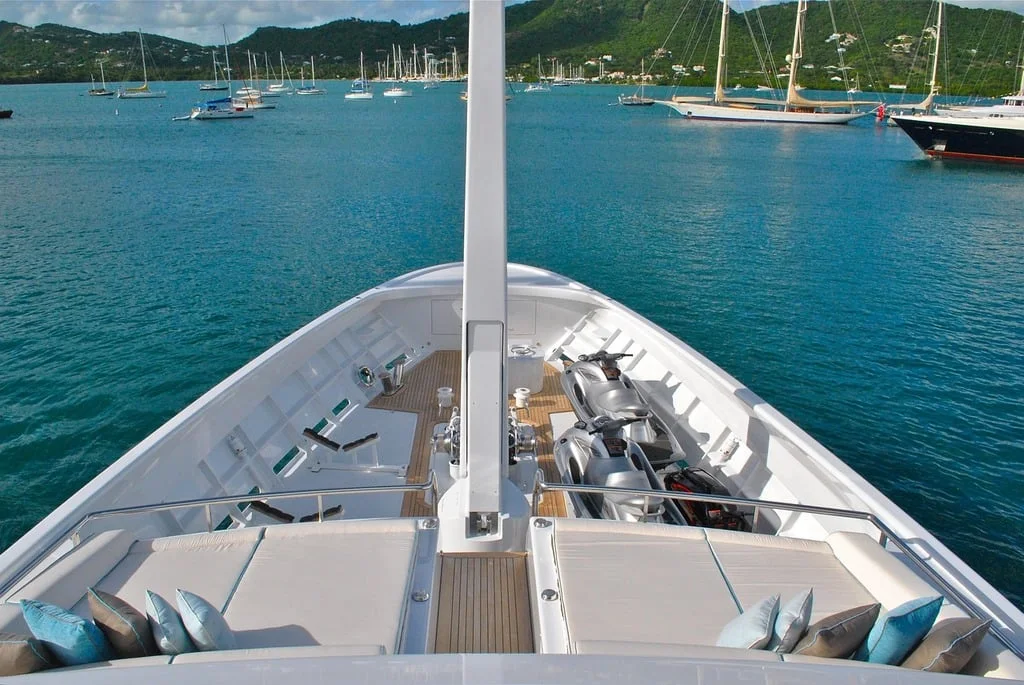 View across the bow of a yacht on blue water